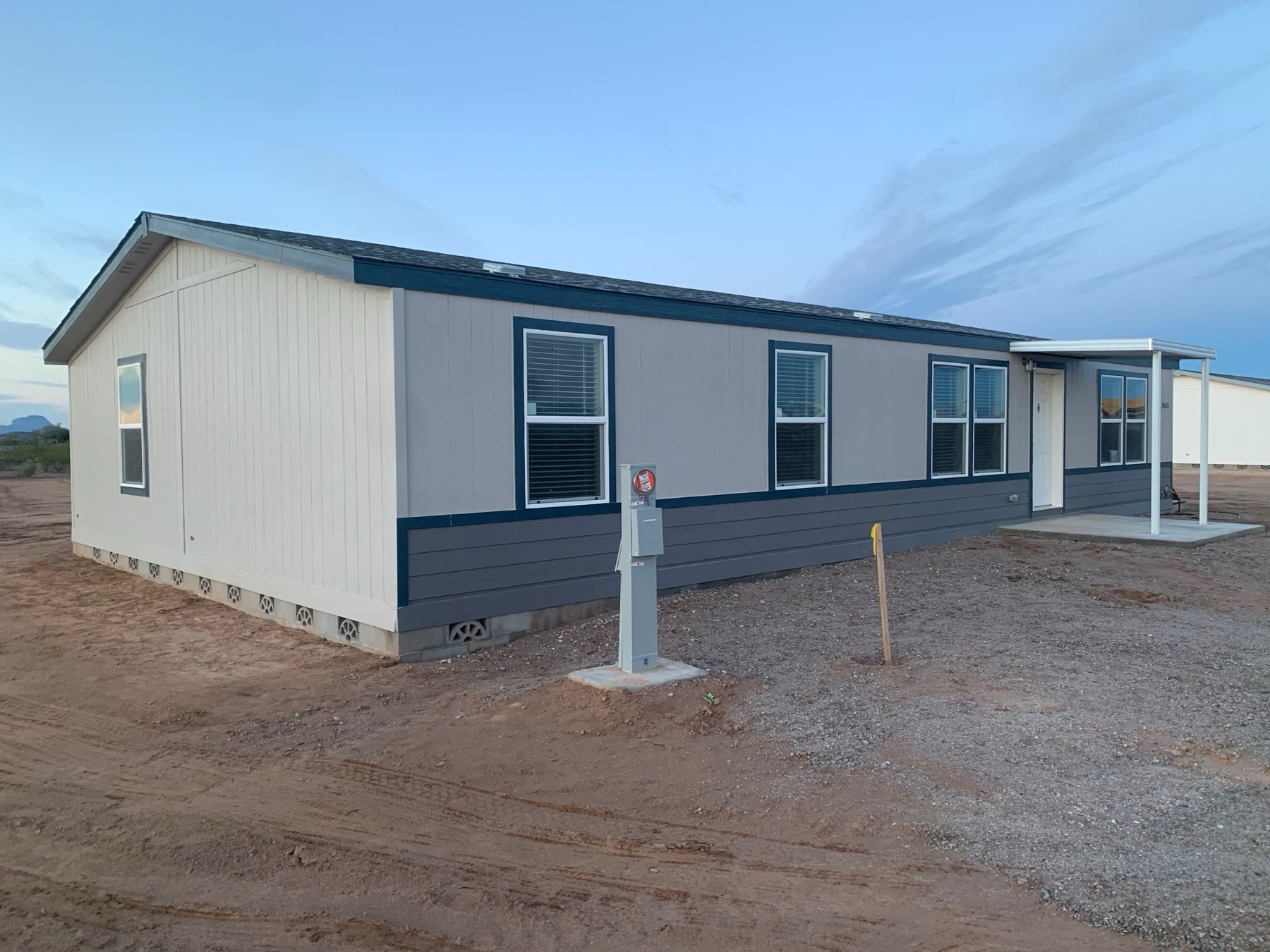 Side of a new home showing the block foundation and finished skirting