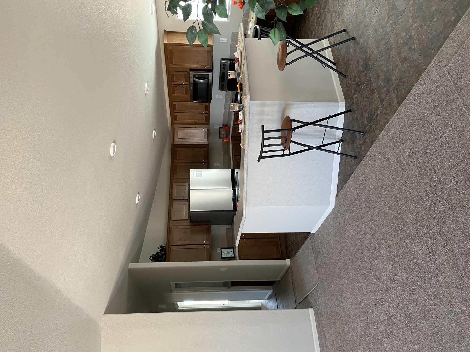 Kitchen with an island, stainless appliances and vaulted ceiling